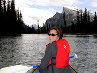 Sharon paddles down the Bow River near Banff with Mount Rundle in the background.