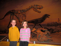 Amy and Riley pose with an Albertosaurus skeleton at the Tyrrell Museum.