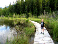 Riley walks along the floating bardwalk on the west end of Middle Lake.
