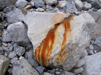 This rock must have had a vein of Iron in it as it looks like rust is pouring out of it.
