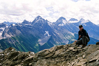 Self portrait part way up with Mount King Albert, Mount Back, and Mount Cradock in the distance.