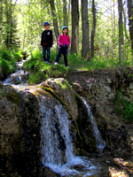 The kids pose atop the nicest falls along the Big Hill Springs trail.