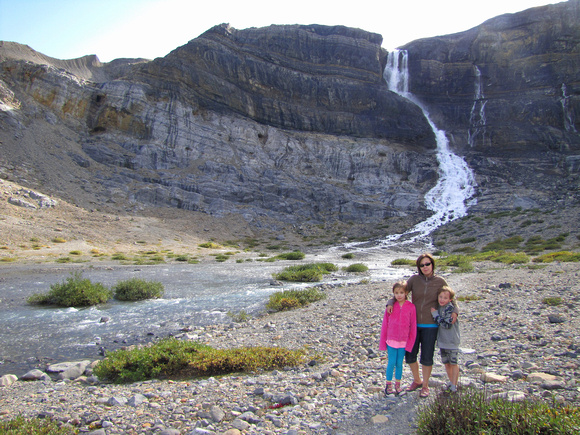 Sharon and the kids pose below the 154 metre tall Bow Glacier Falls.