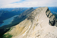 Mount Lougheed's north peak as seen from the true summit. Spray Lake and Big Sister can be seen in the distance.
