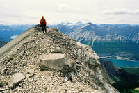 Andrew poses a bit to the west of the summit with Assiniboine looming to the right of him.