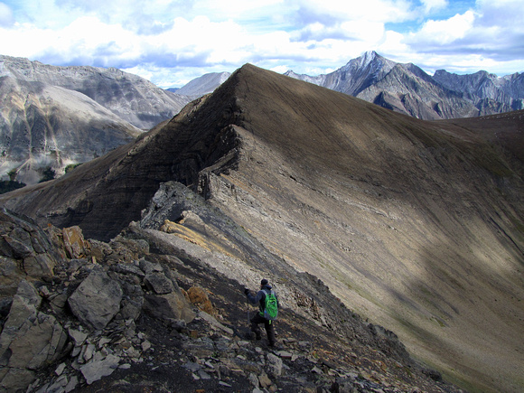 Ahmed starts towards Highwood Ridge with Mount Arethusa on the left and Storm Mountain beyond on the right. The sharp outcrops in the saddle were the most interesting part of the traverse.